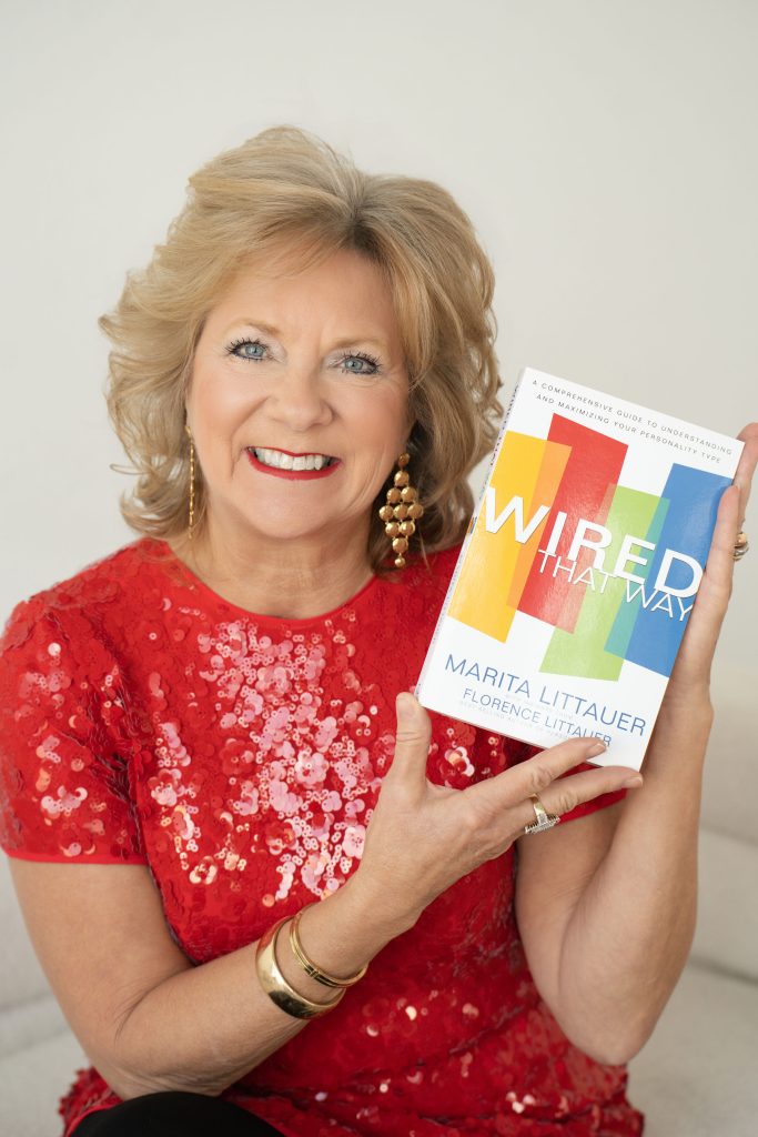 Marita Littauer holds a copy of Wired That Way, illustrating the story behind the book and her lifelong work teaching The Personalities.